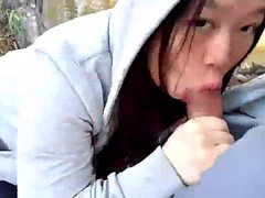 Asian beauty blowing fat dick outside