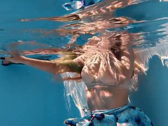 Big boobs blonde babe swimming