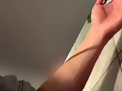 Twink jerks off in a public toilet and cums on a random guy