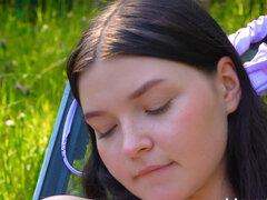 Blushy, small-tittied babe masturbates in the open air