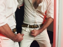 A stunning hunk pleasures himself in front of a mirror, releasing a passionate load that coats the reflective surface.