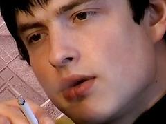 Horny young man smoking before stripping and jerking off solo