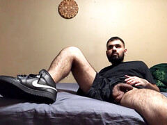 naked stud in sneakers watches tv and spunks a bunch