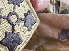Soldier plays with his throbbing hard cock and shoots his load on his army unit patch - part 1