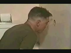 Gay guy sucking on a huge dick at the glory hole