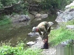 Two military lads resting by the river