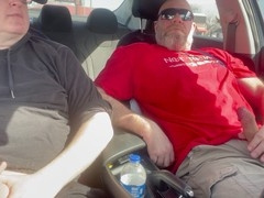 Jerking off our cocks in the car at a parking lot