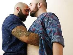 Two hairy and tattooed guys bang hard in their bedroom