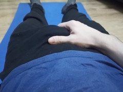 Young dude in green swim trunks enjoys stroking his dick