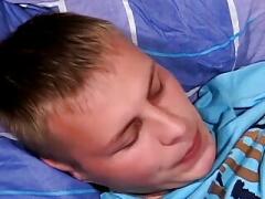 Young gay man passionately strokes his big cock while smoking