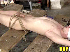 Bound lad victim gives his tormentor an unwilling feet fuck