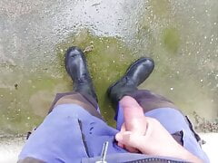 Worker shooting load on wellies after a rainy work day