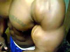 thick dark-hued Bodybuilder Flexing Up Close Grunting