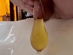 Hot yellow morning piss in a condom