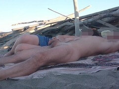 Exhibitionist wife Miss Creamy gives a handjob to a big cock on a nude beach in front of strangers