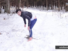 Barefoot Claudia is captured in the cold winter forest
