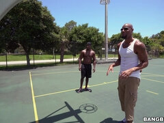 Michelle Martinez playing basketball with three black muscle dudes