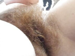 unshaved redhead slut inserts toy in pussy