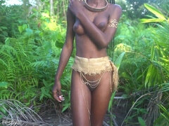 Flawless bod dark flesh African village gal dancing in Raffia half bare outdoor