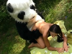 A skinny woman is getting penetrated with a strap on while outdoor