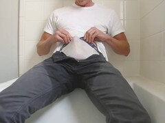 Guy in white trunks peeing in the tub followed by a huge cumshot
