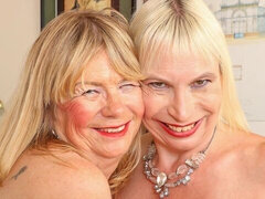 Elle and Barby are enjoying lesbian sex on the black sofa