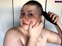 Busty young babe with massive boobs shaves her head completely bald
