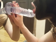 Amateur In Latex Hood Blowing A Dildo