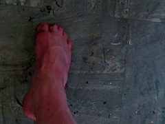 Sissy scrubs a dirty kitchen floor with spit and her feet