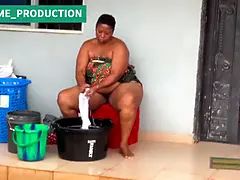 African Mama Multitasks on a Sunday Morning