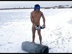 Naked boxer exercises on a frozen lake