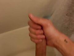 Young slim twink strokes big cock, squirts in the shower.