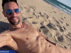 Gym trainer gets nude on a public beach in Spain