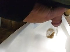 Faggot drinking piss out of a public urinal
