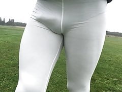 Walking in a public park in white leggings.