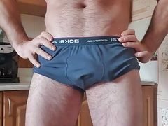 Handsome muscular hairy guy jerks off his huge dick at home