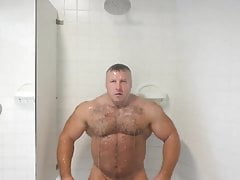 bodybuilder andre mark flexing in shower