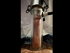 Milking machine sucks and stretches cock