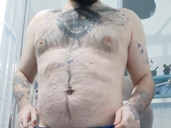 inked unshaved dude blows a load before taking a bathroom