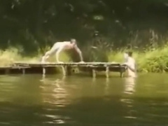 Young men skinny dip in a river.