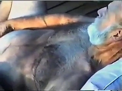 Young Boy Inhales Off a Fur covered Grandfather