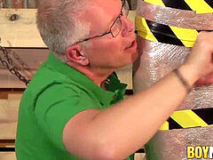 Old dominant guy jacks strapped subs cock and makes him cum