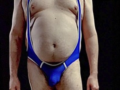 Mature coach with massive belly suits up in a tight singlet and shows off his bulge