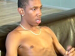 UK black twink Bobby cums hard after stroking his massive cock
