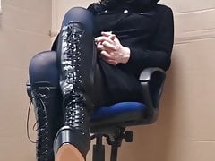 Crossdresser posing in boots and stockings.