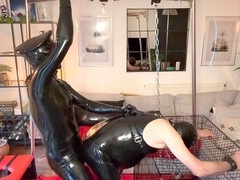 Latex master brings the heat as he dominates his slave in the cage