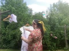 In vintage floral pattern dress for a day hanging laundry