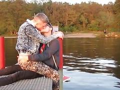 Loving boyfriends share a passionate kiss on a pier