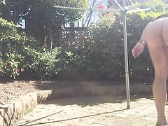 Hanging out washing in g string and naked in garden