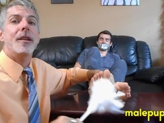 Professor Richard Lennox tickles the feet of his young student Kody Tracer